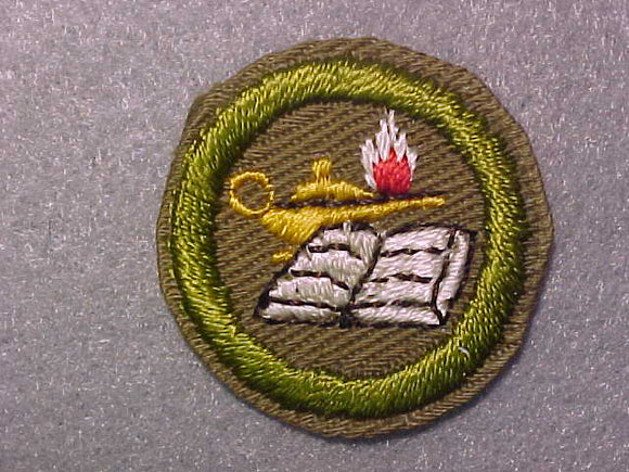 READING, MERIT BADGE WITH CRIMPED EDGE, TAN, ISSUED 1936-45