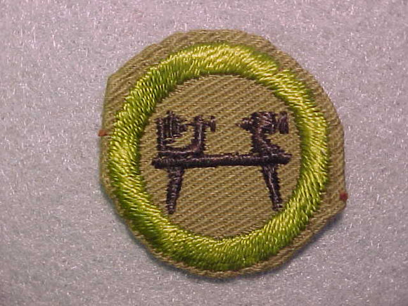 WOOD TURNING, MERIT BADGE WITH CRIMPED EDGE, TAN, ISSUED 1936-45