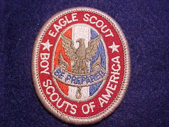 EAGLE RANK, TYPE 12D, WHITE BORDERS ON WHITE STRIPE BETWEEN RED AND BLUE, NARROW OVAL KNOT BELOW SCROLL, SCOUT STUFF IMPRINT PLASTIC BACK, 2002-