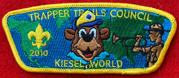 Trapper Trails Council 2010 Camp Kiesel Commerative CSP SA-137. 'Kiesel World' Text with Camp Mascot Embroidery Detailing. Yellow Border. Mint Condition.