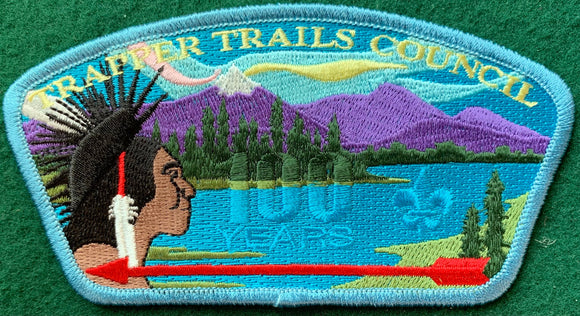 Trapper Trails Council CSP SA-143. '100 Years' Text Ghosted into Background Embroidery. Light Blue Border. Mint Condition.