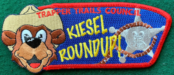 Trapper Trails Council 2011 Camp Kiesel Commerative Edition CSP SA-155. 'Kiesel Roundup' Text and Camp Mascot Embroidery Detailing. Red Border. Mint Condition.