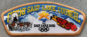 Great Salt Lake Council 2002 Salt Lake Winter Olympics Commerative Edition CSP SA-102. Embroidered Bull-Drawn Covered Wagon, Olympic Logo, and Skeleton Bobsled Details. Tan Border. Mint Condition.