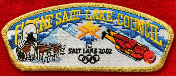 Great Salt Lake Council 2002 Salt Lake Winter Olympics Commerative Edition CSP SA-104. Embroidered Bull-Drawn Covered Wagon, Olympic Logo, and Skeleton Bobsled Details. Gold Mylar Border. Mint Condition.