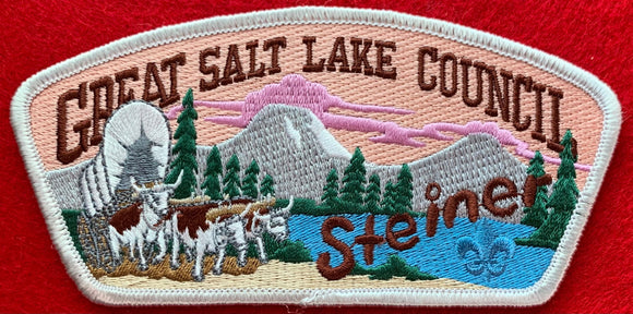 Great Salt Lake Council Camp Steiner CSP SA-131. Embroidered Bull-Drawn Covered Wagon with Wooded Mountain Lake Background. Brown Camp Steiner Logo Detail. White Border. Mint Condition.