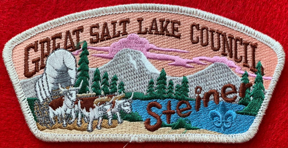 Great Salt Lake Council Camp Steiner CSP SA-132. Embroidered Bull-Drawn Covered Wagon with Wooded Mountain Lake Background. Brown Camp Steiner Logo Detail. Silver Mylar Border. Mint Condition.