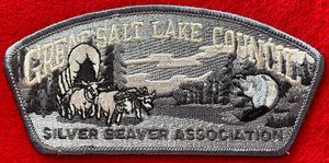 Great Salt Lake Silver Beaver Association Commerative CSP SA-136. Full Gray-Scale Embroidery. Bull-Drawn Covered Wagon, Wooded Background, and Beaver Details. Silver Mylar Council Name. Gray Border. Mint Condition.