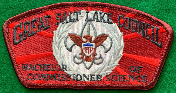 Great Salt Lake Council 'Bachelor of Commissioner Science' Edition CSP SA-148. Gray and Brown Scouting Fleur-de-lis within Silver Wreath Embroidered Details. Red/Dark Red Background. Dark Red Border. Mint Condition.