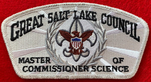 Great Salt Lake Council 'Master of Commissioner Science' Edition CSP SA-149. Gray and Brown Scouting Fleur-de-lis within Silver Wreath Embroidered Details. White/Silver Background. Silver Mylar Border. Mint Condition.