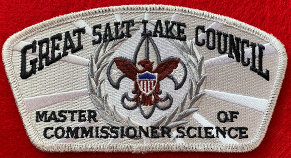 Great Salt Lake Council 'Master of Commissioner Science' Edition CSP SA-149. Gray and Brown Scouting Fleur-de-lis within Silver Wreath Embroidered Details. White/Silver Background. Silver Mylar Border. Mint Condition.