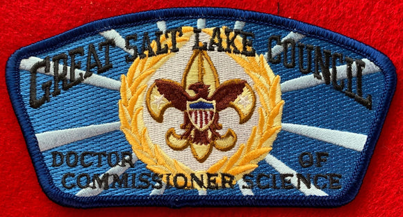 Great Salt Lake Council 'Doctor of Commissioner Science' Edition CSP SA-150. Gold and Brown Scouting Fleur-de-lis within Gold Wreath Embroidered Details. Blue/Light Blue Background. Blue Mylar Border. Mint Condition.