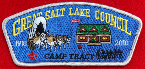 Great Salt Lake Council 2010 Camp Tracy Commerative Edition CSP SA-206. Embroidered Bull-Drawn Covered Wagon and Camp Building on Blue Background. Silver Border. Mint Condition.