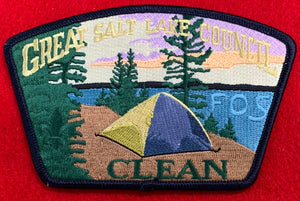 Great Salt Lake Council Friends of Scouting (FOS) Edition CSP SA-208. Embroidered Yellow Tent Infront of Lakeside Wooded Background with 'Clean' Detail. Black Border. Mint Condition.