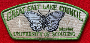 Great Salt Lake Council 'Master' University of Scouting Commerative CSP SA-229. Embroidered Black and White Butterfly. Scouting Fleur-de-lis and Venturing Logo Ghosted into Tan Background. Olive Green Border. Mint Condition.