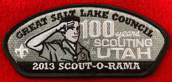 Great Salt Lake Council 2013 Scout-O-Rama Commerative CSP SA-253. Scout Saluting with Text Reading '100 Years of Scouting in Utah' Embroidered Detailing. Black Border. Mint Condition.