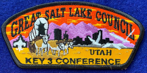 Great Salt Lake Council, Utah: Key 3 Conference Commerative CSP SA-81. Bull-Drawn Covered Wagon with Orange, Purple, and Yellow Mountain Range Background Embroidered Details. Mint Condition.