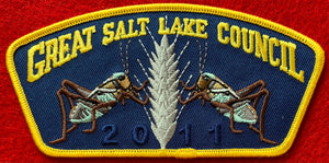 Great Salt Lake Council CSP TA-215. Two Embroidered Crickets/Grasshoppers(?) near a Grain of Wheat on a Dark Blue Background. '2011' Ghosted into the Dark Blue Background. Yellow Border. Mint Condition.