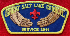 Great Salt Lake Council 2011 Service Commerative CSP TA-219. Embroidered Open Palms with a Red Fleur-de-lis on a Dark Blue Background. Yellow Border. Mint Condition.