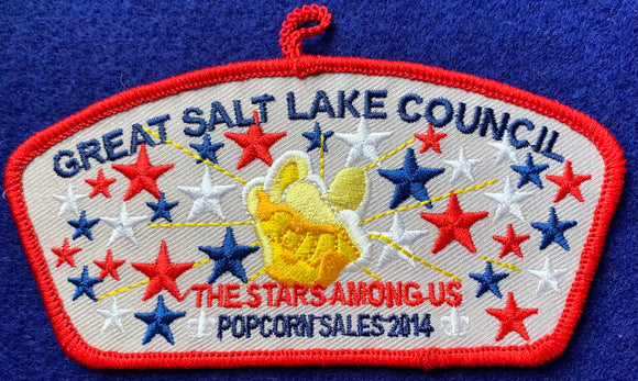 Great Salt Lake Council Popcorn Sales 2014 Commerative CSP TA-271. Embroidered Popcorn Kernal Surrounded by Red, White, and Blue Star Details. 'The Stars Among Us' Text. Red Border and Loop on Top. Mint Condition.