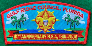 Gulf Ridge Council 90th Anniversary of the BSA Commerative CSP SA-20. Embroidered Radiant Scouting Fleur-de-lis Centered on Coastal Background. Red Border. Mint Condition.