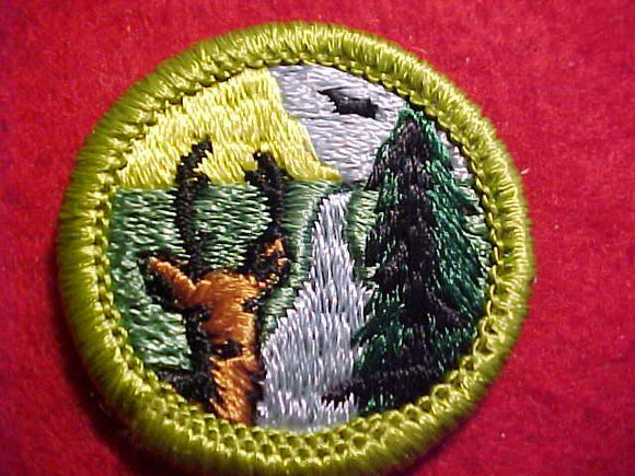 CONSERVATION OF NATURAL RESOURCES, MERIT BADGE WITH CLEAR PLASTIC BACK, GREEN BORDER, NO IMPRINTS/LOGOS IN PLASTIC, 1972-73