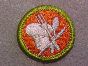 COOKING, MERIT BADGE WITH CLEAR PLASTIC BACK, GREEN BORDER, NO IMPRINTS/LOGOS IN PLASTIC