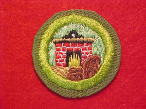 CITIZENSHIP IN THE HOME, MERIT BADGE WITH CRIMPED EDGE, KHAKI, ISSUED 1946-60