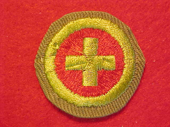 FIRST AID, MERIT BADGE WITH CRIMPED EDGE, KHAKI, ISSUED 1946-60