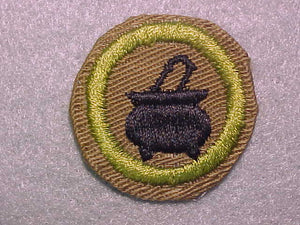 COOKING, MERIT BADGE WITH CRIMPED EDGE, TAN, ISSUED 1936-45
