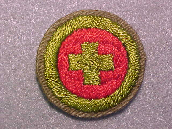 FIRST AID, MERIT BADGE WITH CRIMPED EDGE, TAN, ISSUED 1936-45