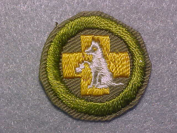 FIRST AID TO ANIMALS, MERIT BADGE WITH CRIMPED EDGE, TAN, ISSUED 1936-45