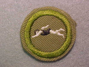 SWIMMING, MERIT BADGE WITH CRIMPED EDGE, TAN, ISSUED 1936-45